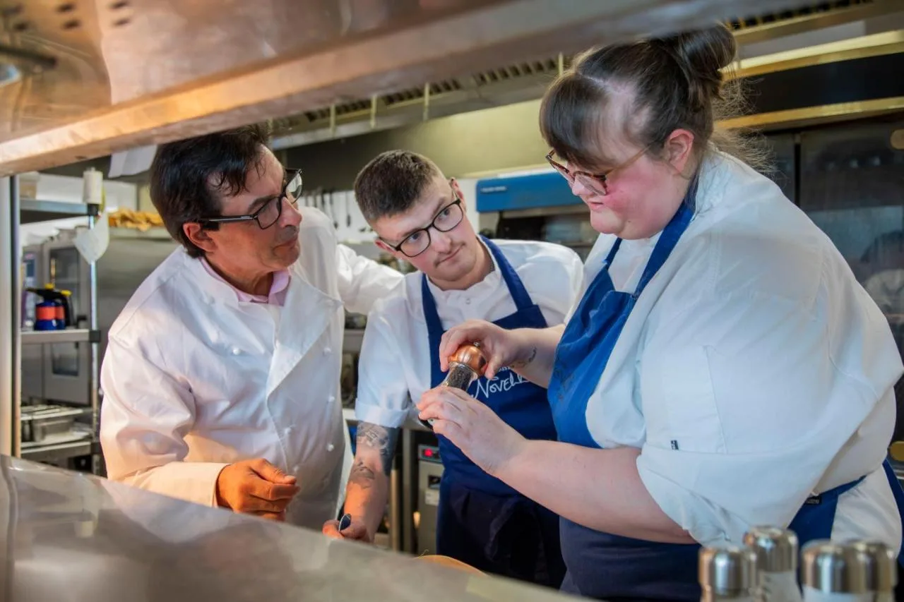 a group of three chefs working in a kitchen at AC Hotel by Marriott Belfast in Belfast