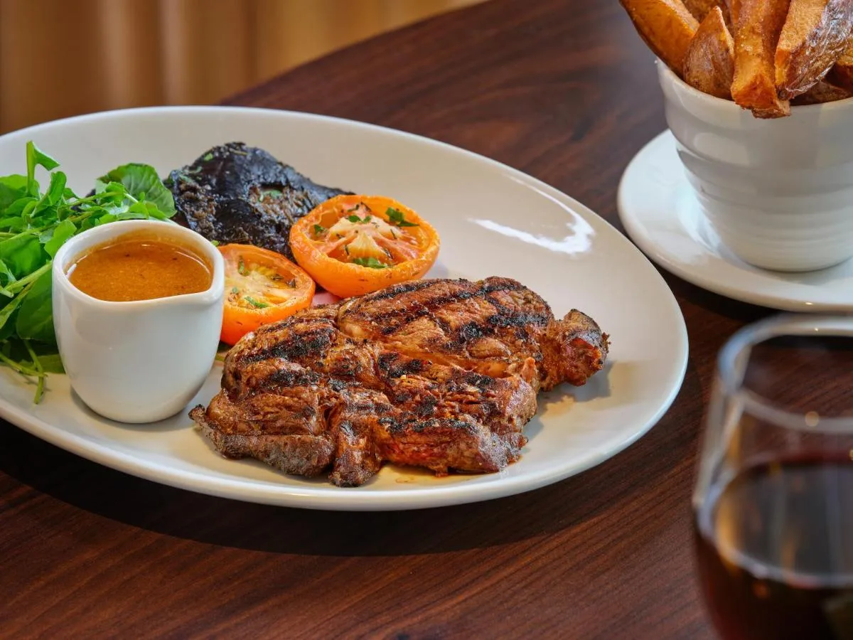 a plate of food with meat and vegetables on a table at AC Hotel by Marriott Belfast in Belfast